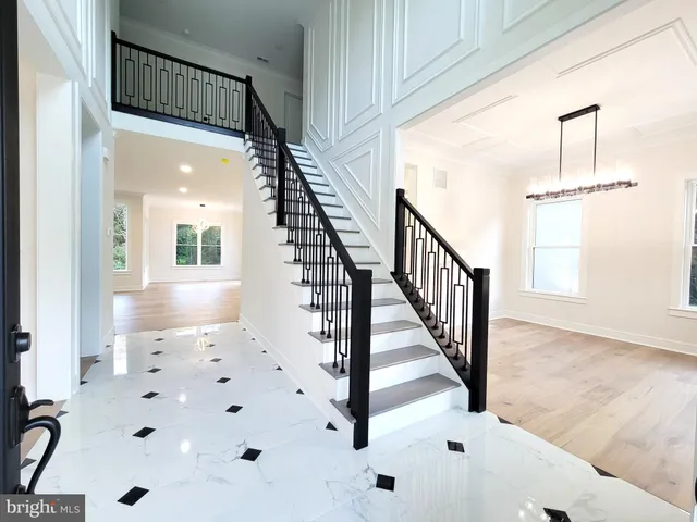 a view of staircase with white walls and windows