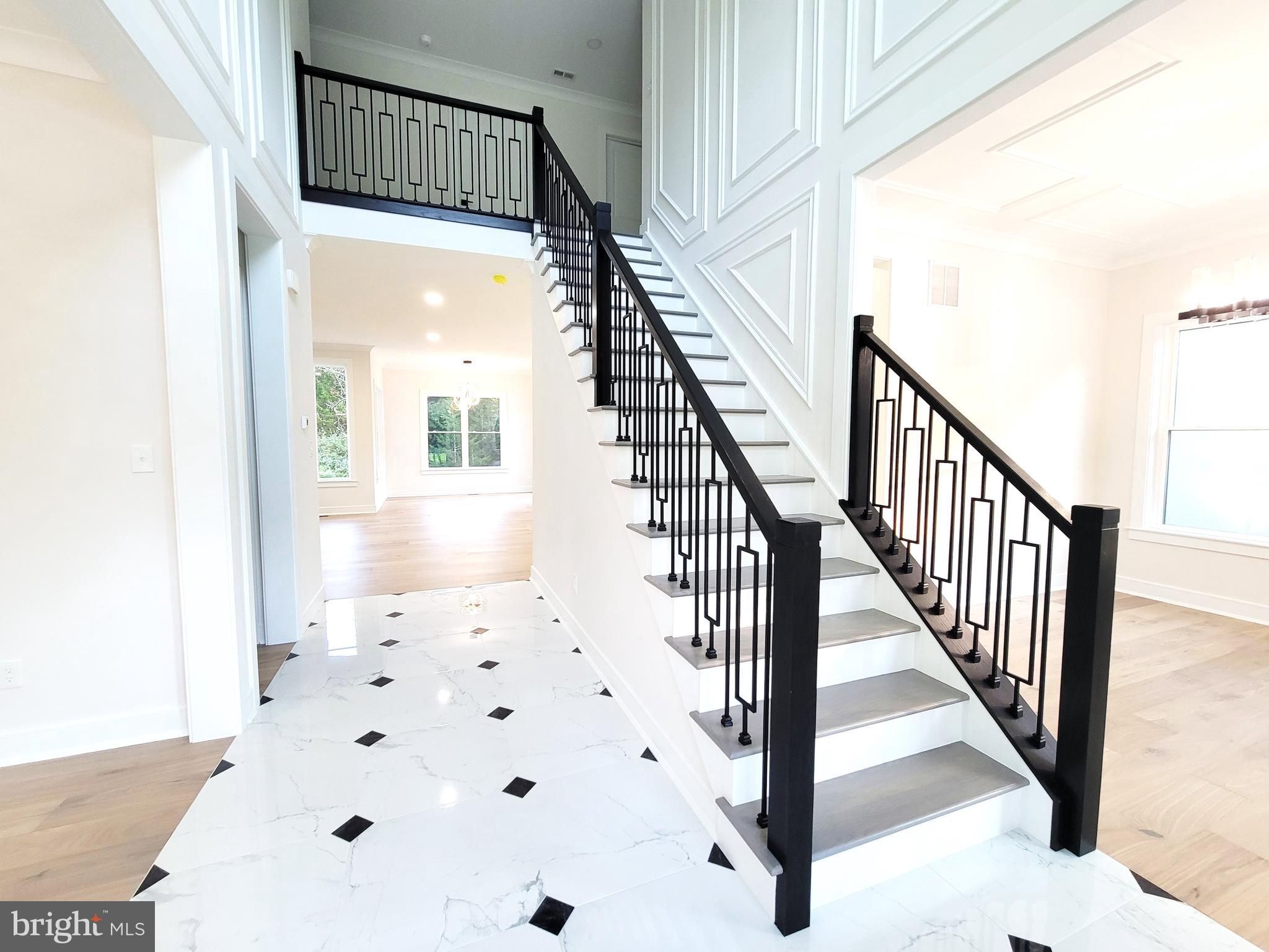 4517 Ascher Road Vineland, NJ 08361 - Photo 18 of 52 a view of a hallway with wooden floor and staircase