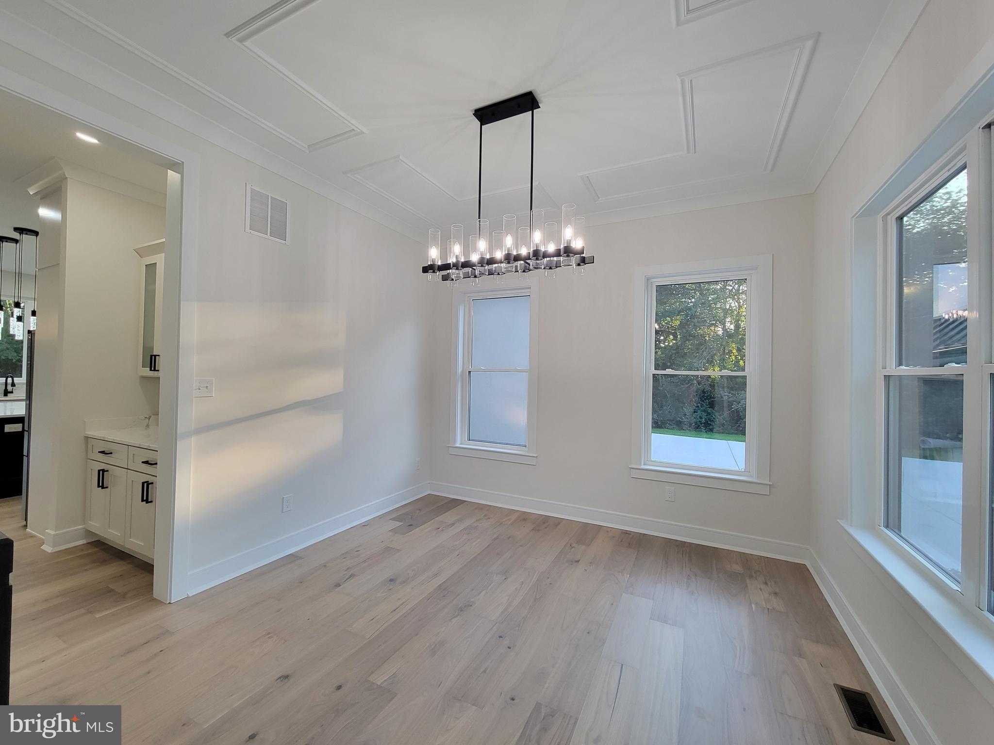 4517 Ascher Road Vineland, NJ 08361 - Photo 22 of 52 an empty room with wooden floor cabinet and windows