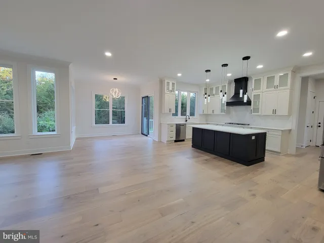 a large kitchen with a large window and stainless steel appliances