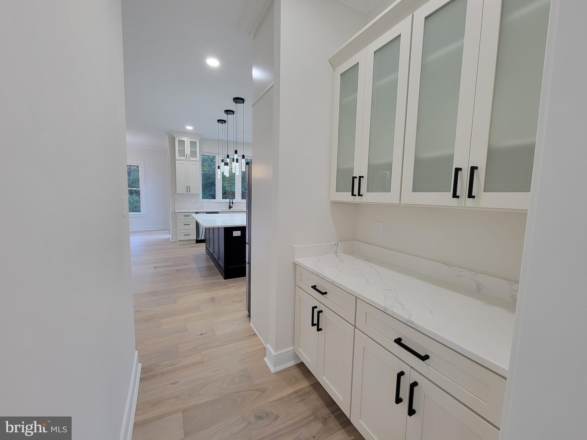 4517 Ascher Road Vineland, NJ 08361 - Photo 23 of 52 a view of a hallway with wooden floor and cabinet