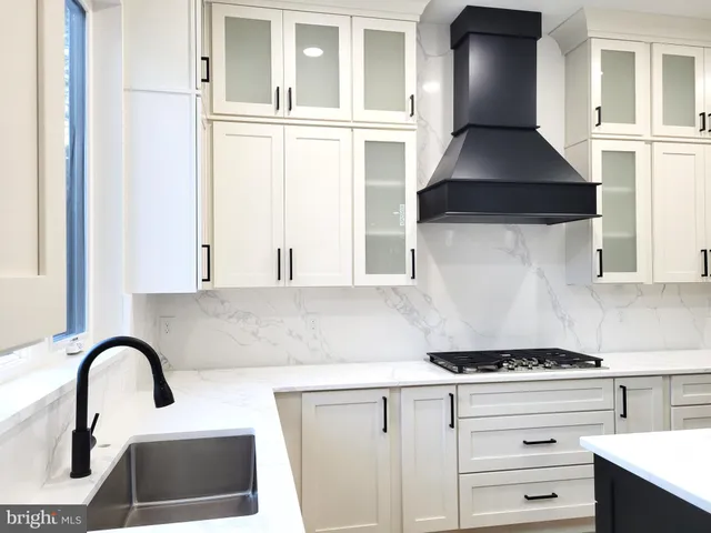 a kitchen with granite countertop a stove and a sink