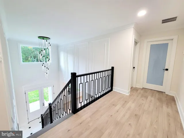 a view of an entryway with wooden floor