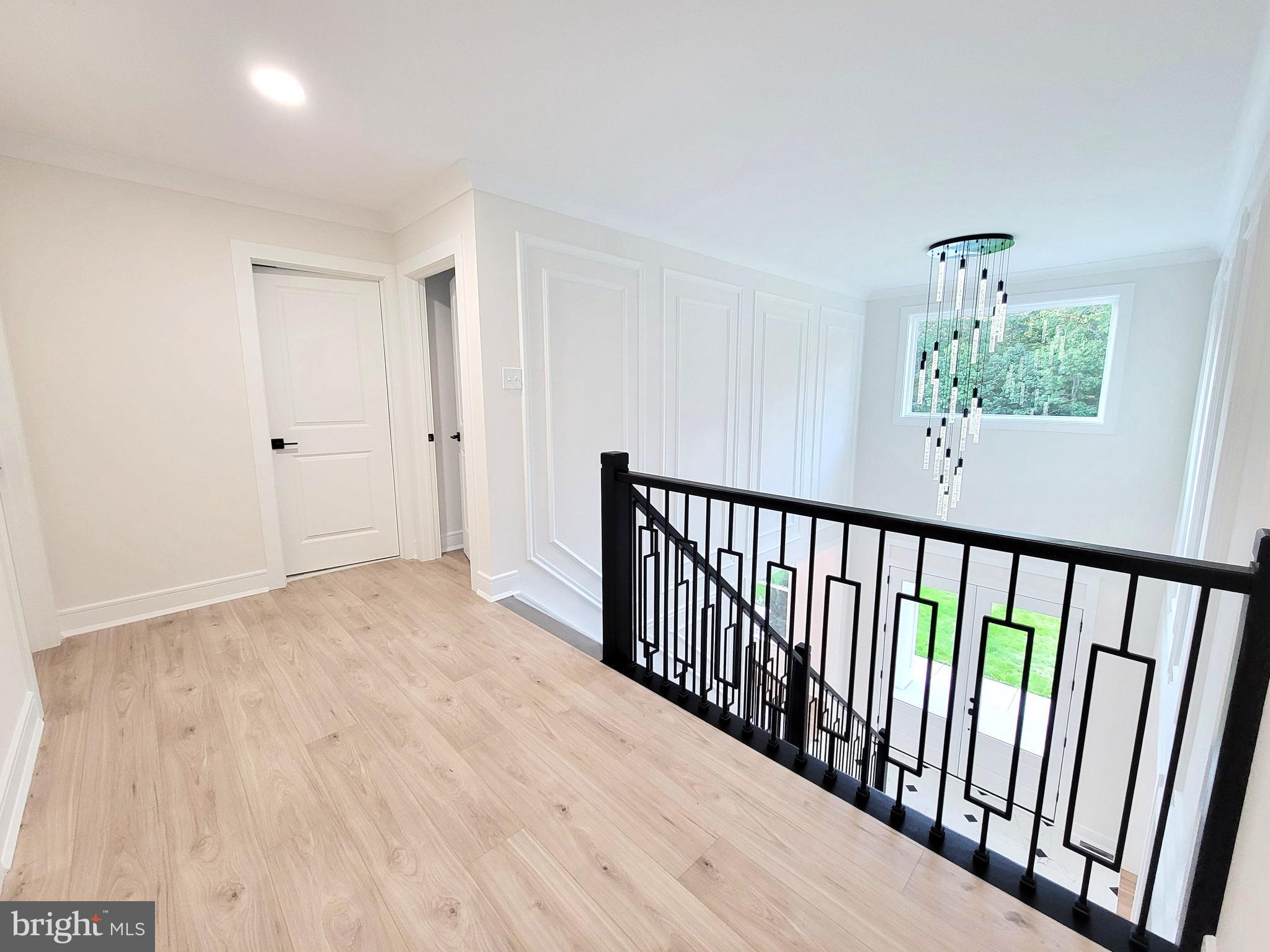 4517 Ascher Road Vineland, NJ 08361 - Photo 40 of 52 a view of a hallway with wooden floor and stairs