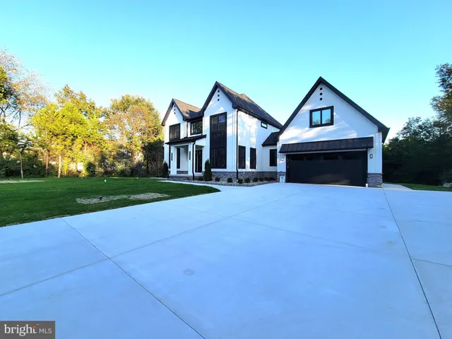 a front view of a house with yard and green space
