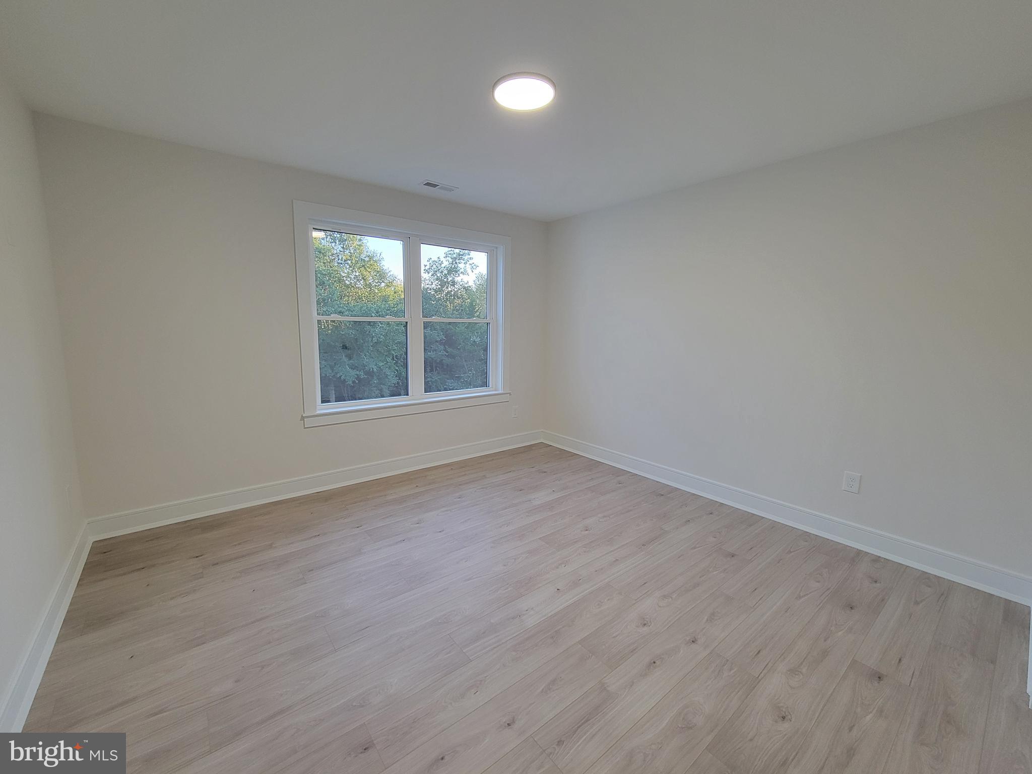 4517 Ascher Road Vineland, NJ 08361 - Photo 44 of 52 an empty room with wooden floor and windows