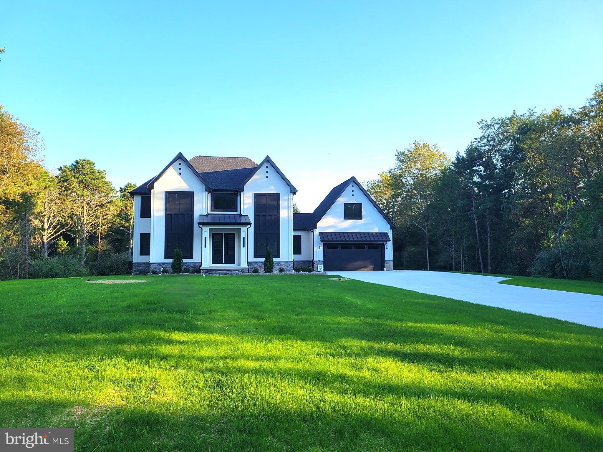 4517 Ascher Road Vineland, NJ 08361 - Photo 5 of 52 a view of a big house with a big yard and large trees