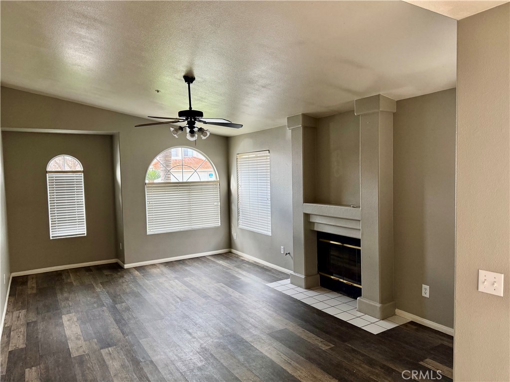 372 Via Capri Hemet, CA 92545 - Photo 12 of 27 an empty room with wooden floor fireplace and windows