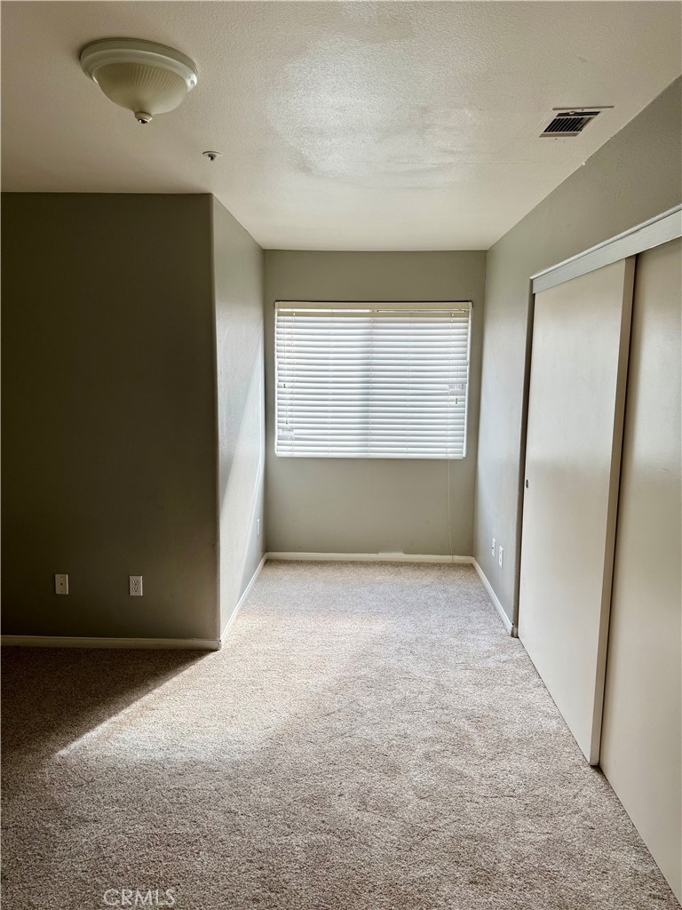 372 Via Capri Hemet, CA 92545 - Photo 13 of 27 an empty room with a window and a refrigerator