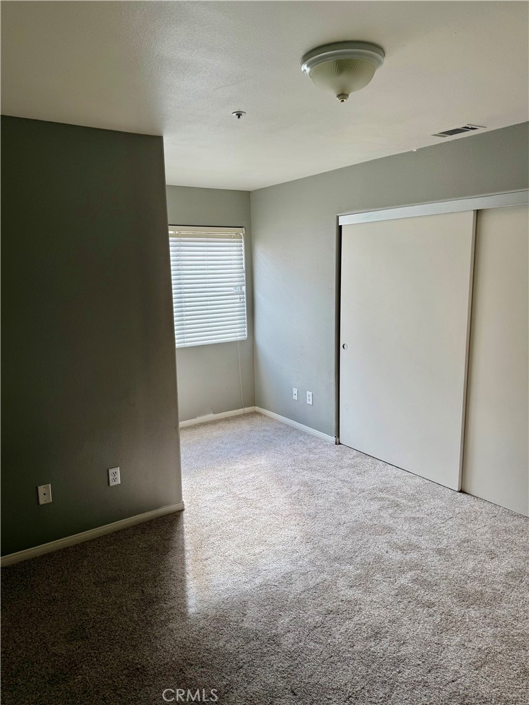372 Via Capri Hemet, CA 92545 - Photo 15 of 27 an empty room with closet and windows