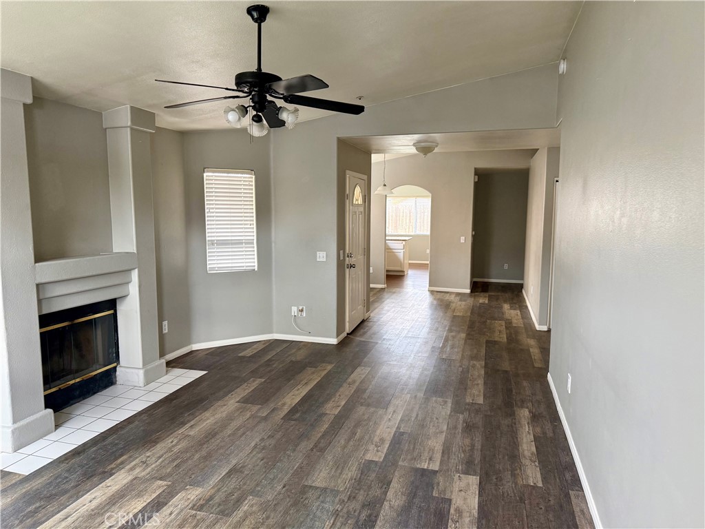 372 Via Capri Hemet, CA 92545 - Photo 4 of 27 a view of a hallway with wooden floor and a fireplace