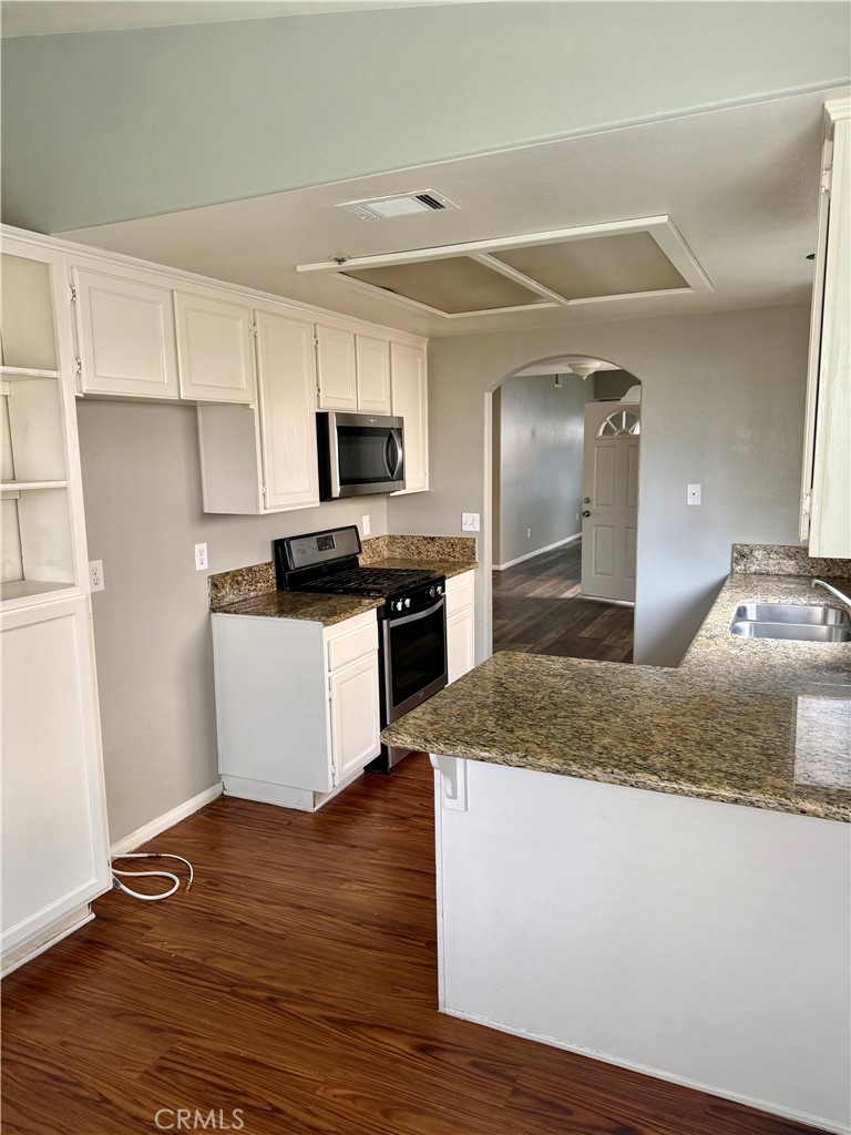 372 Via Capri Hemet, CA 92545 - Photo 7 of 27 a kitchen with stainless steel appliances granite countertop a stove a sink and a refrigerator