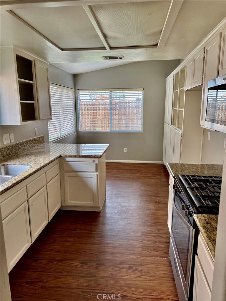 372 Via Capri Hemet, CA 92545 - Photo 8 of 27 a kitchen with granite countertop a stove and a sink