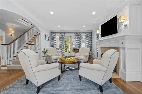 a living room with fireplace furniture and a flat screen tv