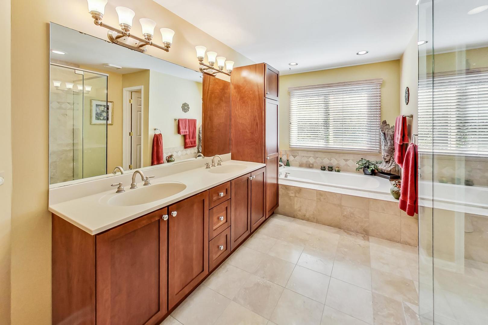 4763 Middle Road Gurnee, IL 60031 - Photo 21 of 47 a bathroom with a sink double vanity granite tub shower and a mirror