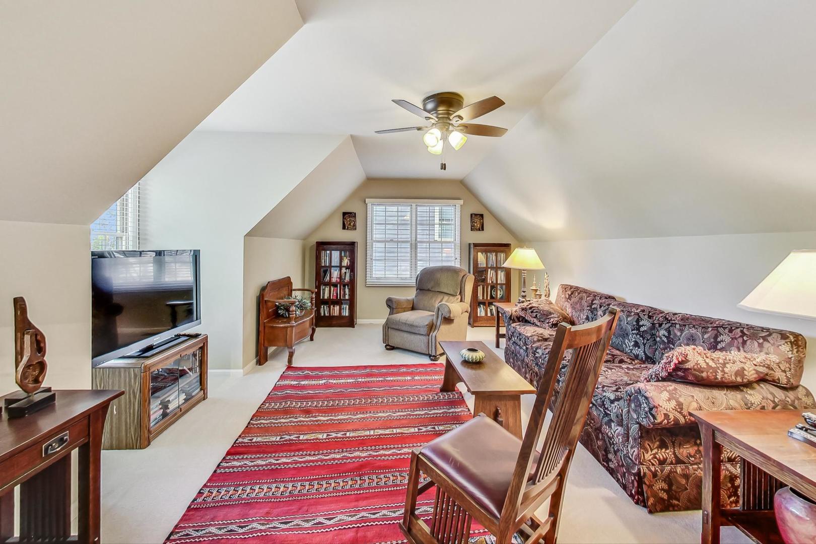 4763 Middle Road Gurnee, IL 60031 - Photo 26 of 47 a living room with furniture a flat screen tv and a fireplace