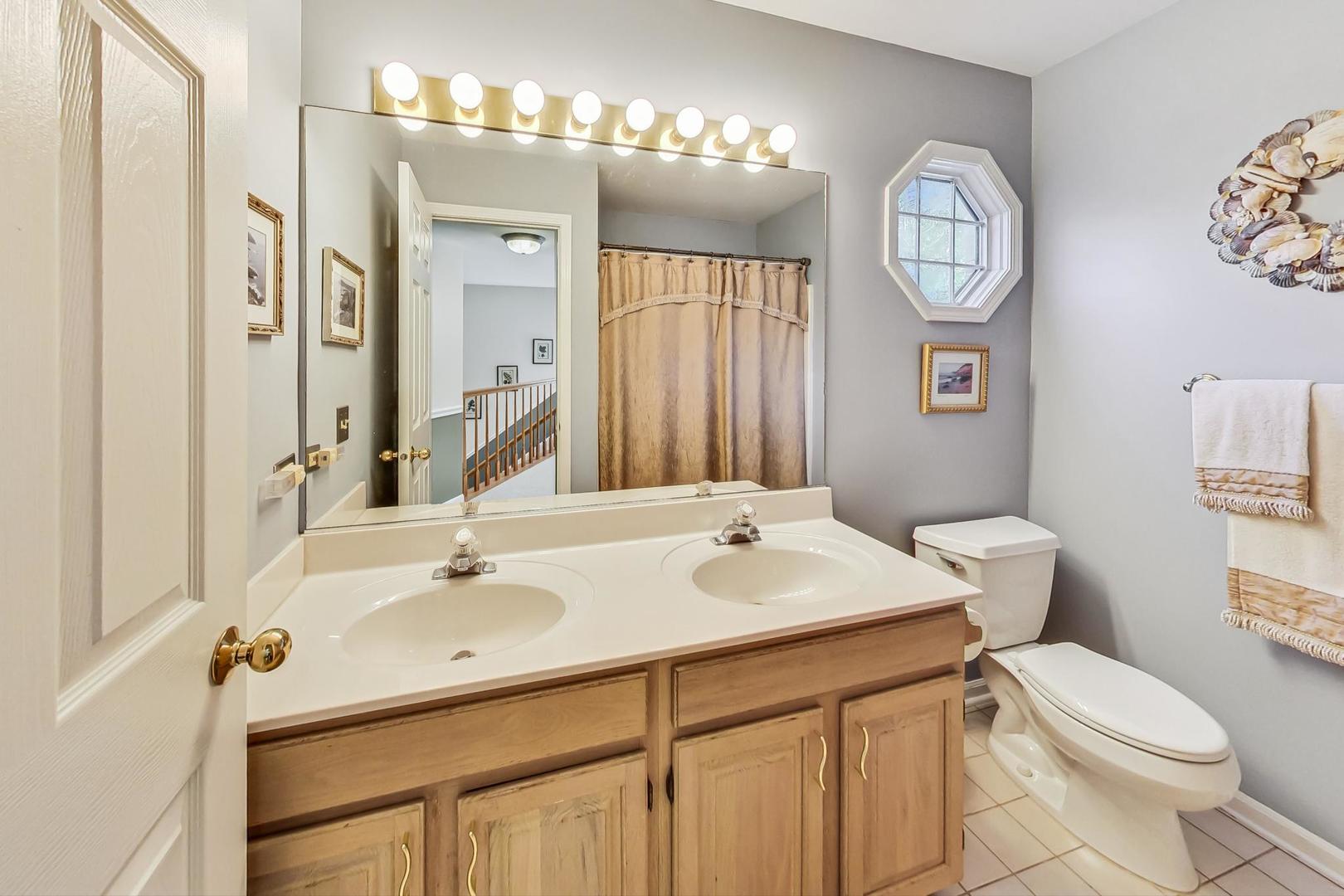 4763 Middle Road Gurnee, IL 60031 - Photo 27 of 47 a bathroom with a sink a toilet and a mirror