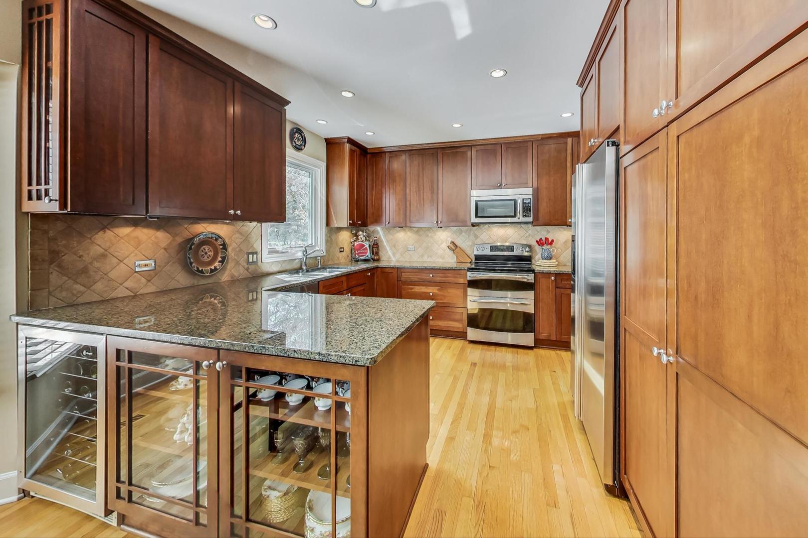 4763 Middle Road Gurnee, IL 60031 - Photo 8 of 47 a kitchen with stainless steel appliances granite countertop a stove a sink and a microwave