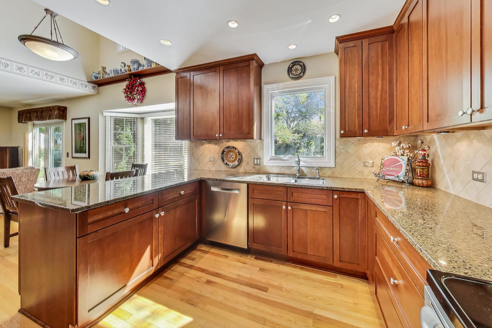 4763 Middle Road Gurnee, IL 60031 - Photo 9 of 47 a large kitchen with kitchen island granite countertop a large window