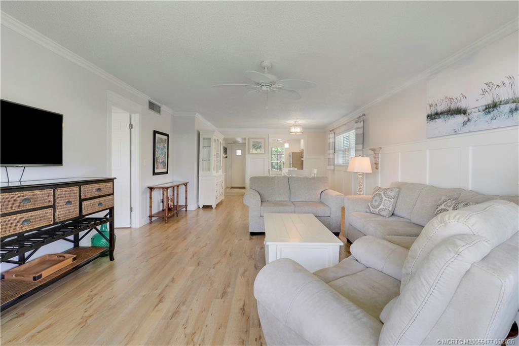 1852 Southwest Palm City Road, Unit 201 Stuart, FL 34994 - Photo 7 of 34 a living room with furniture and a flat screen tv