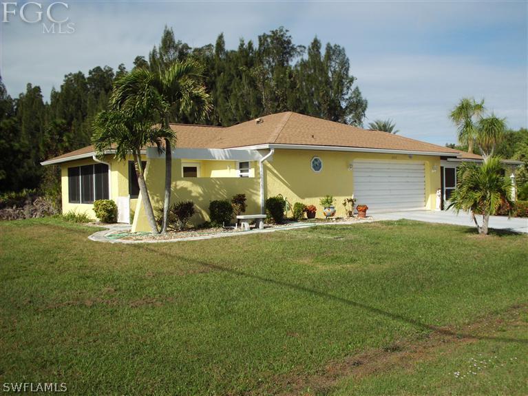 5919 Tarpon Road Bokeelia, FL 33922 - Photo 3 of 14 a front view of a house with a yard