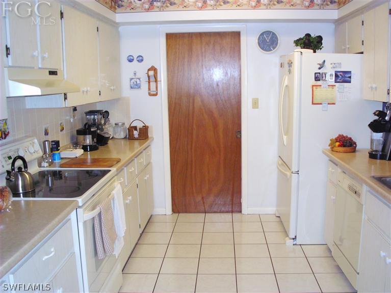 5919 Tarpon Road Bokeelia, FL 33922 - Photo 9 of 14 a kitchen with a sink and cabinets