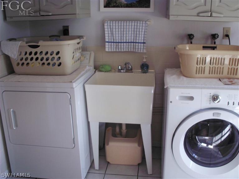 5919 Tarpon Road Bokeelia, FL 33922 - Photo 10 of 14 a utility room with dryer and washer