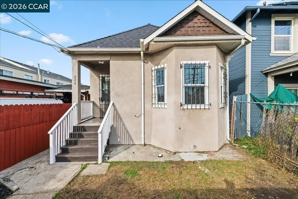 a front view of a house with wooden fence