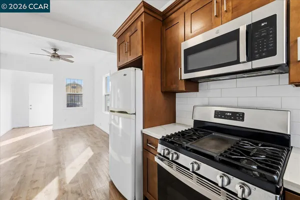 a kitchen with stainless steel appliances granite countertop a stove and a microwave