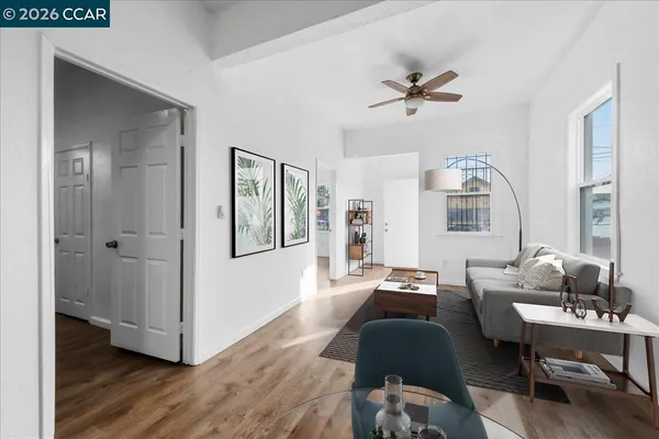 a living room with furniture and wooden floor