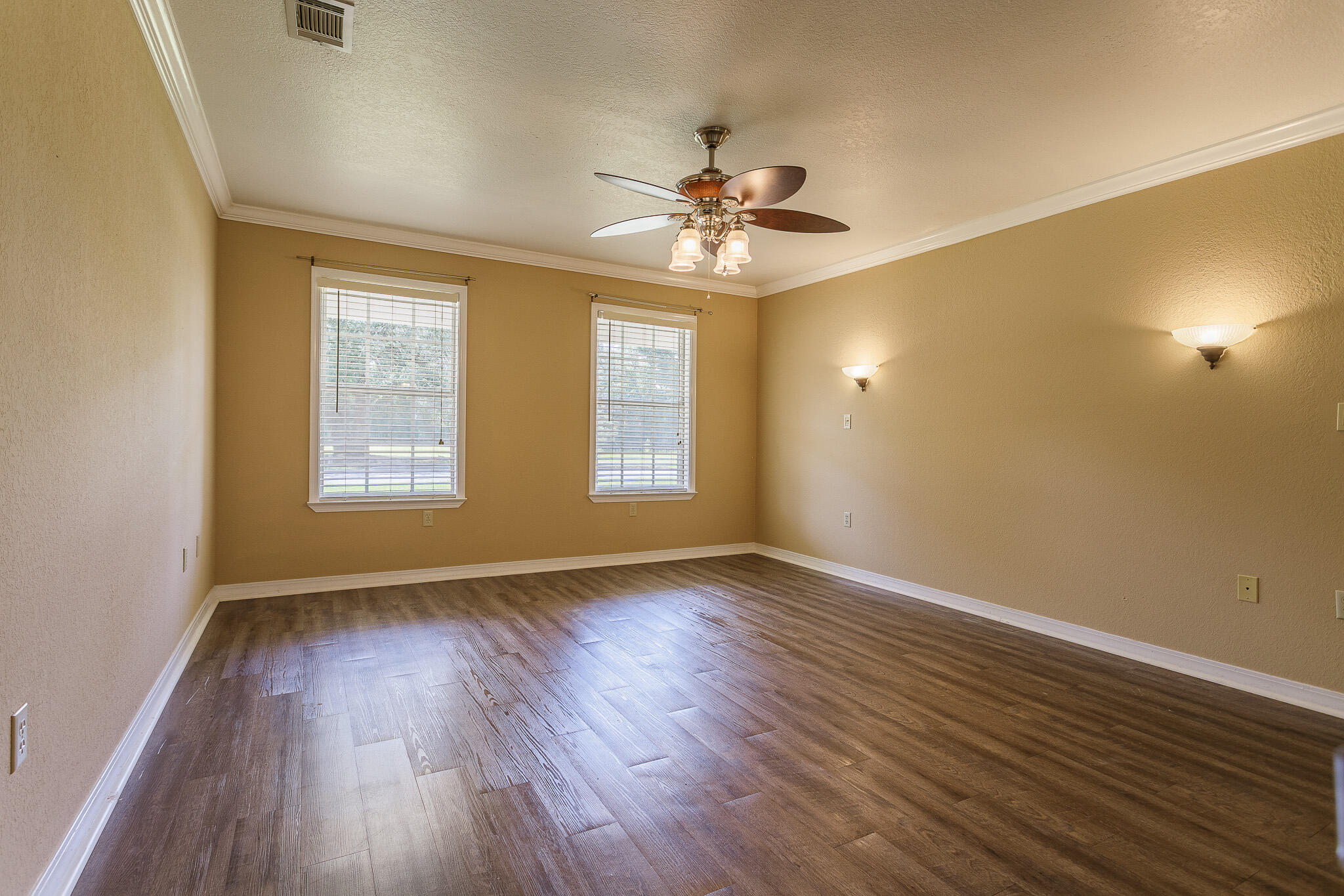 329 Skyline Circle Crestview, FL 32539 - Photo 11 of 28 a view of an empty room with wooden floor and a window