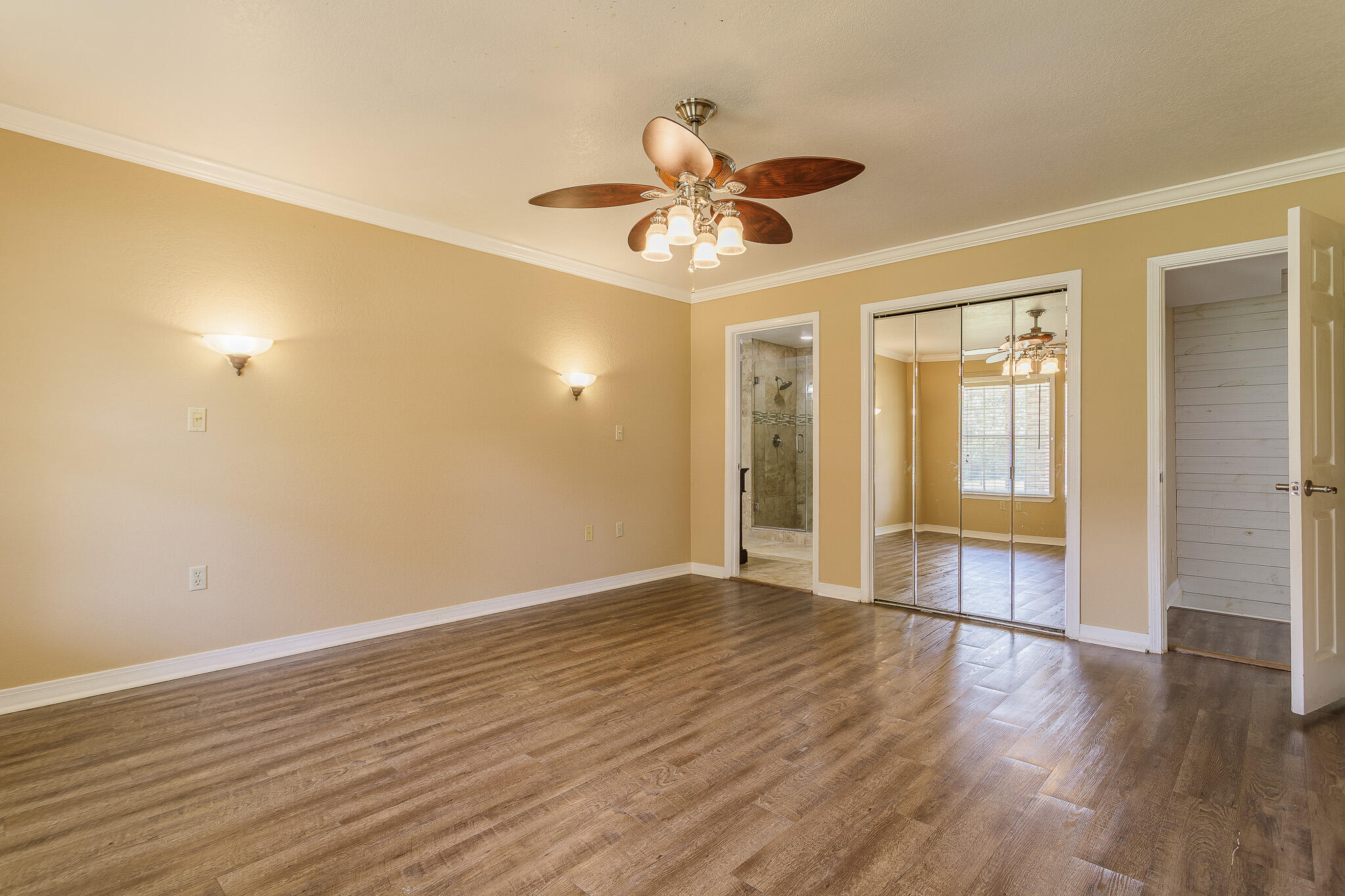 329 Skyline Circle Crestview, FL 32539 - Photo 12 of 28 a view of an empty room with wooden floor and a window