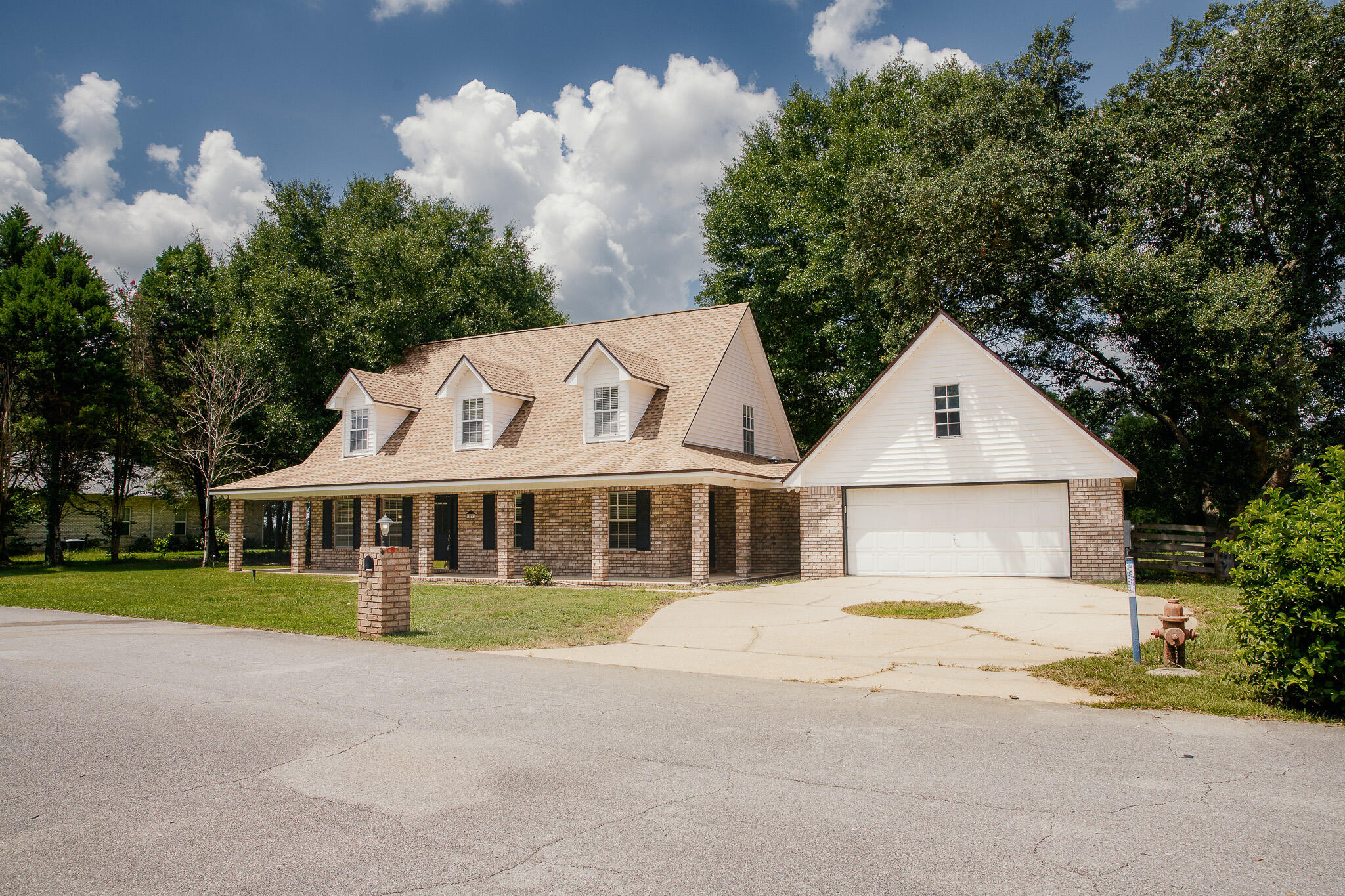 329 Skyline Circle Crestview, FL 32539 - Photo 2 of 28 a view of a white house with a yard and plants