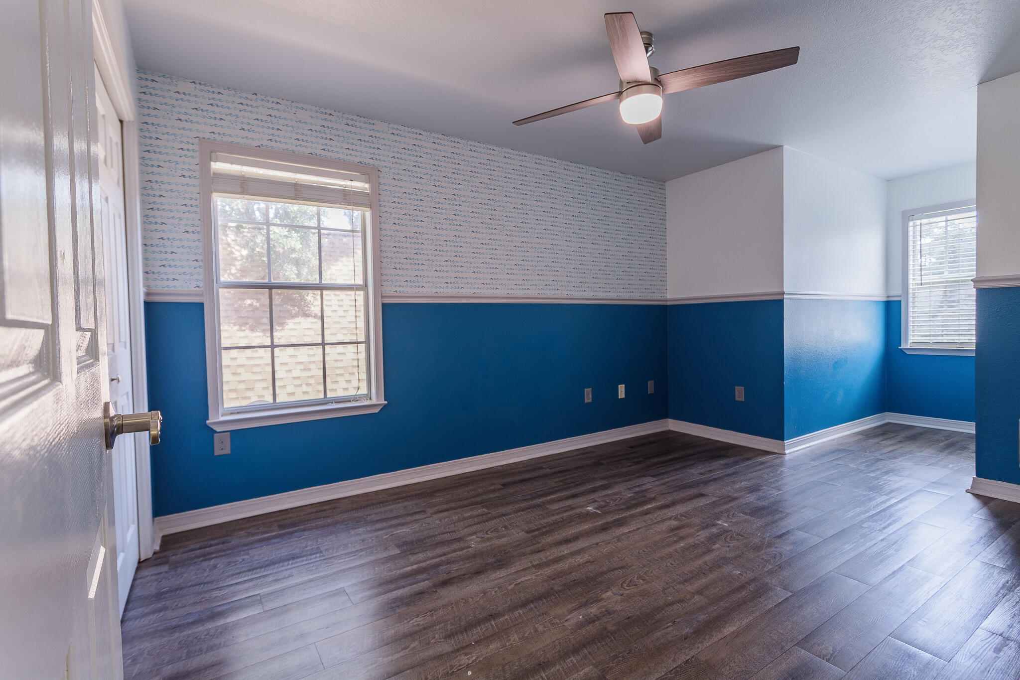 329 Skyline Circle Crestview, FL 32539 - Photo 22 of 28 a view of an empty room with a window and wooden floor