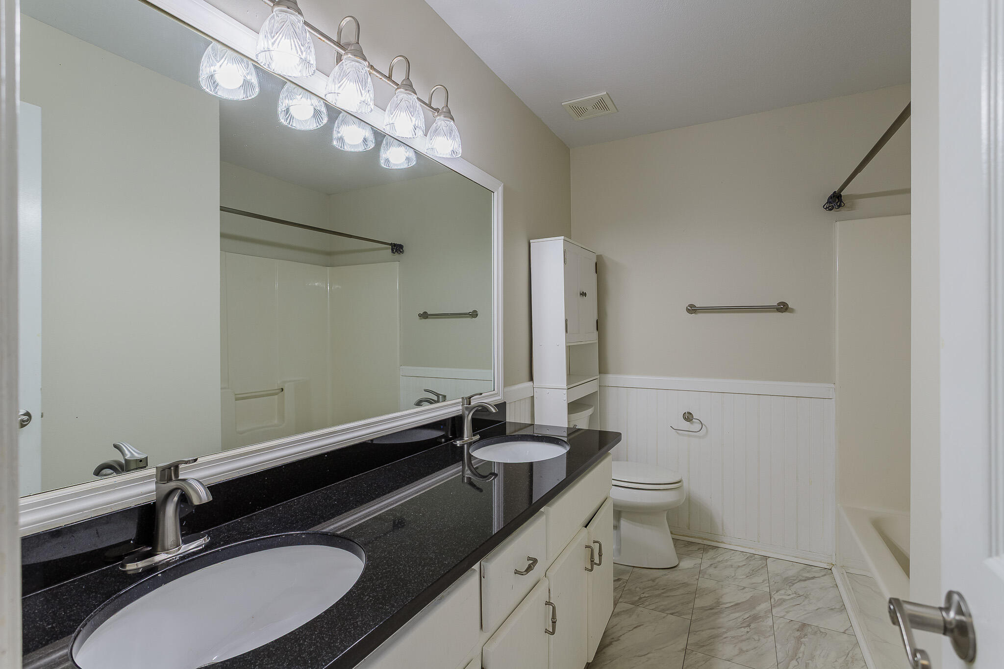 329 Skyline Circle Crestview, FL 32539 - Photo 23 of 28 a bathroom with a granite countertop sink toilet a mirror a vanity and shower