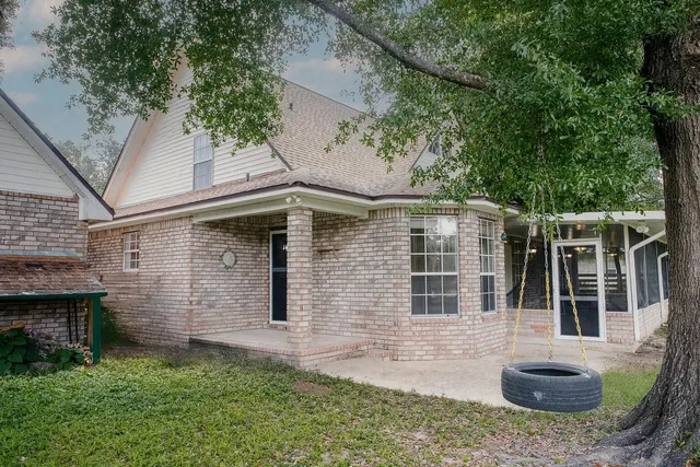 a view of backyard with a table and a chairs