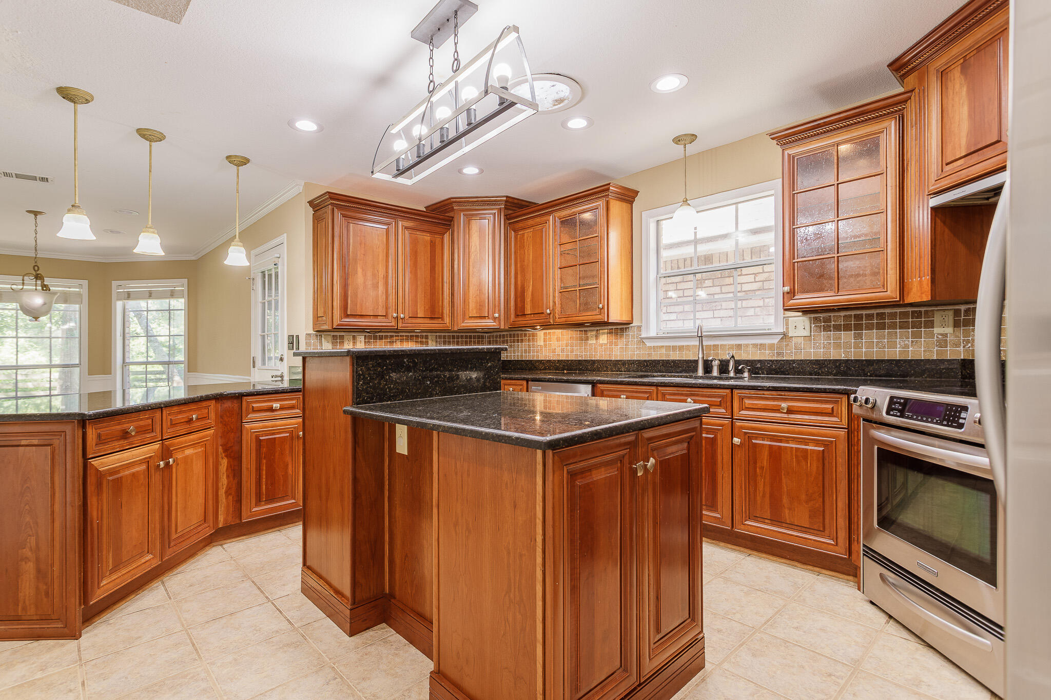 329 Skyline Circle Crestview, FL 32539 - Photo 3 of 28 a kitchen with stainless steel appliances granite countertop a sink a stove and a refrigerator