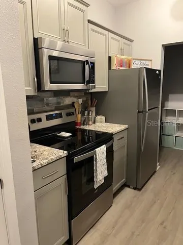 a kitchen with a stove microwave and refrigerator