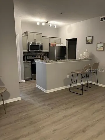 a kitchen with stainless steel appliances a refrigerator and a stove top oven