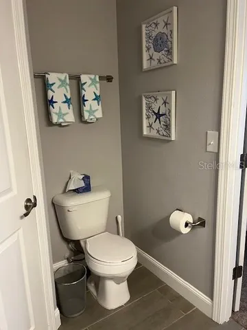 a white toilet sitting next to a bathroom sink