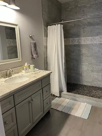 a bathroom with a double vanity sink and mirror
