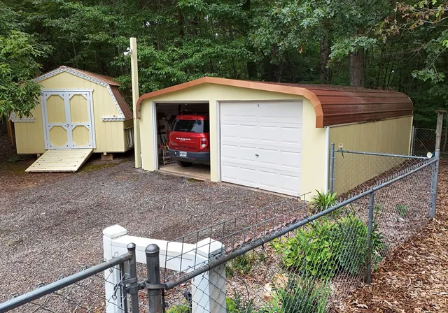 a view of a deck with couches table and chairs with wooden floor and fence