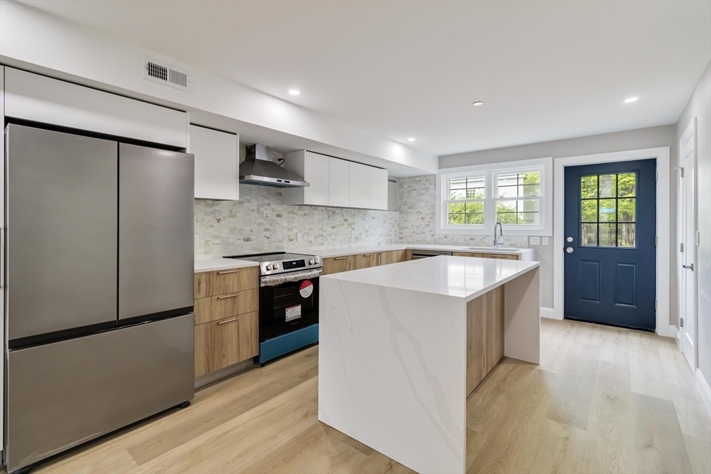 192 Main Street, Unit D Medway, MA 02053 - Photo 1 of 39 a kitchen with stainless steel appliances granite countertop a refrigerator a sink a stove and a refrigerator
