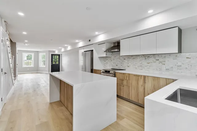 a kitchen with a sink a stove and cabinets