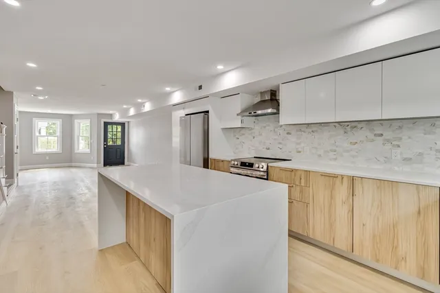 a kitchen with stainless steel appliances a sink stove and cabinets