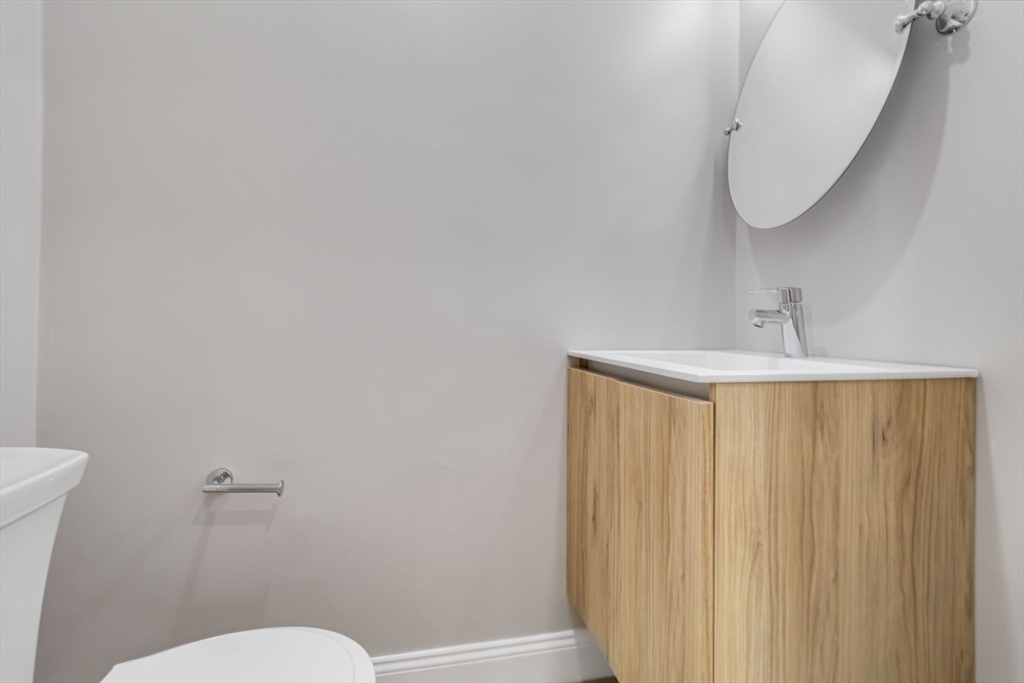 192 Main Street, Unit D Medway, MA 02053 - Photo 16 of 39 a bathroom with a sink and a mirror