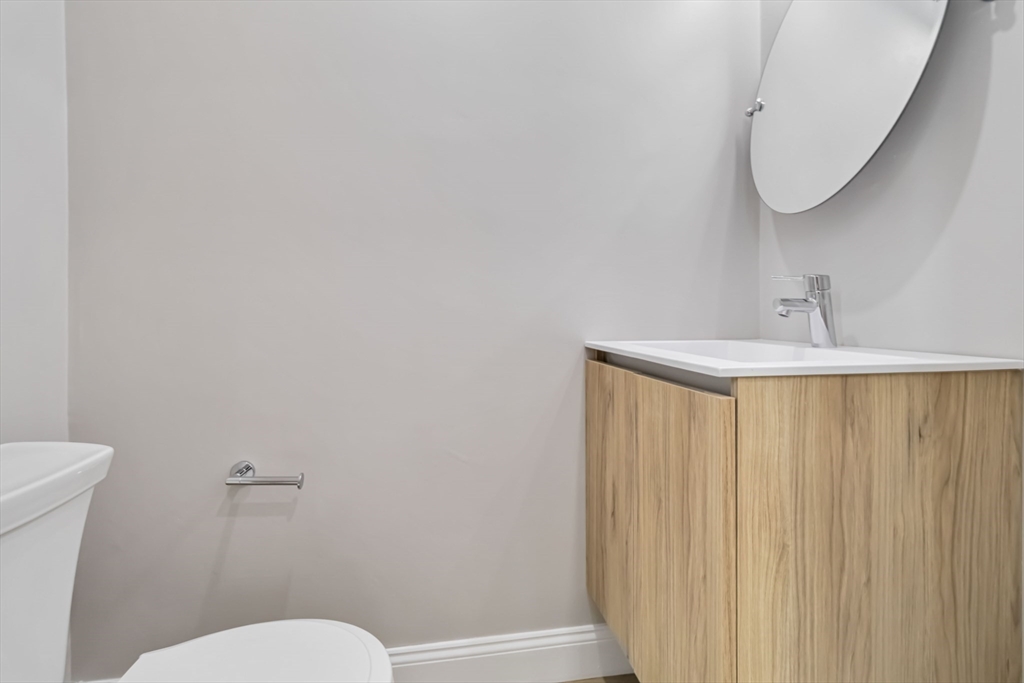 192 Main Street, Unit D Medway, MA 02053 - Photo 17 of 39 a bathroom with a sink and a mirror