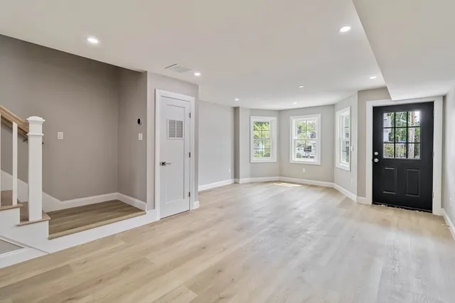 an empty room with windows and closet