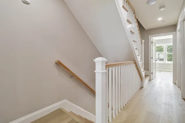 a view of a hallway with wooden floor and entryway
