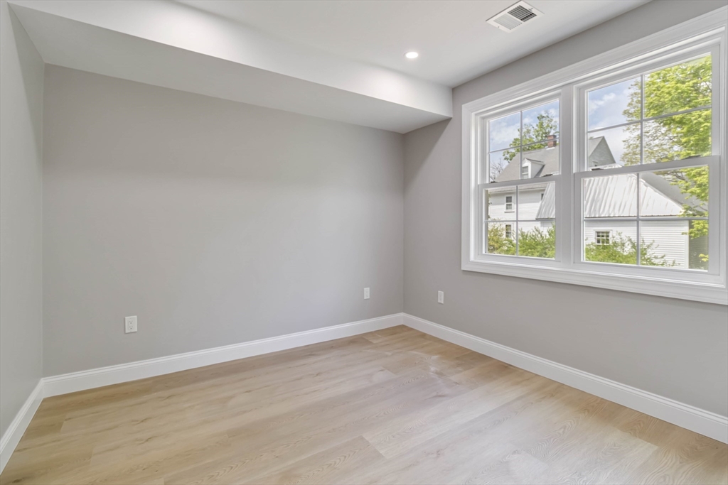 192 Main Street, Unit D Medway, MA 02053 - Photo 22 of 39 an empty room with wooden floor and windows